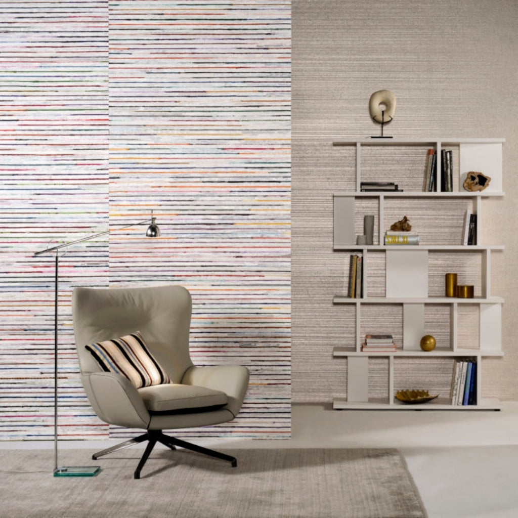 colorful striped wallpaper in a gray home office. Shelf with books and a leather armchair