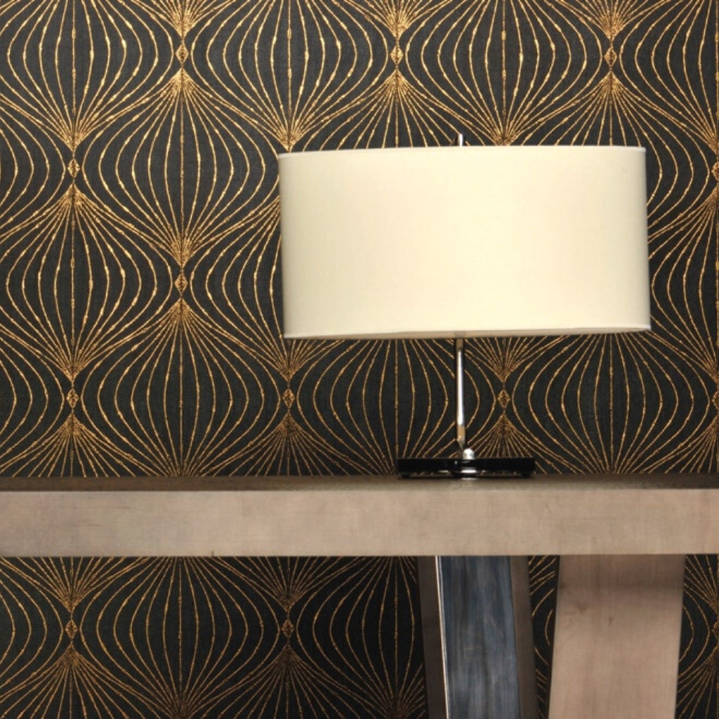 gold and black patterned wallpaper and a white lamp