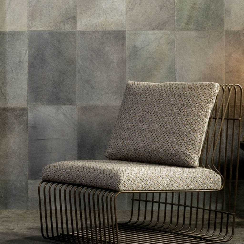 metal frame chair with a velvety cover/ The wallpaper is made of cowhide leather and its pattern is of a square shape